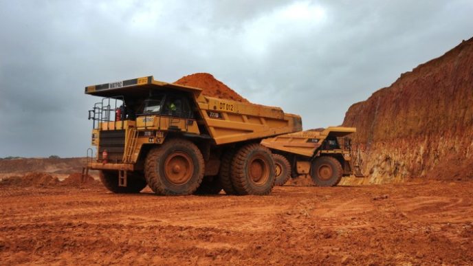 Earth movers travel through the pit of an Iluka Resources mineral sands mine in Douglas, north of Hamilton, Australia