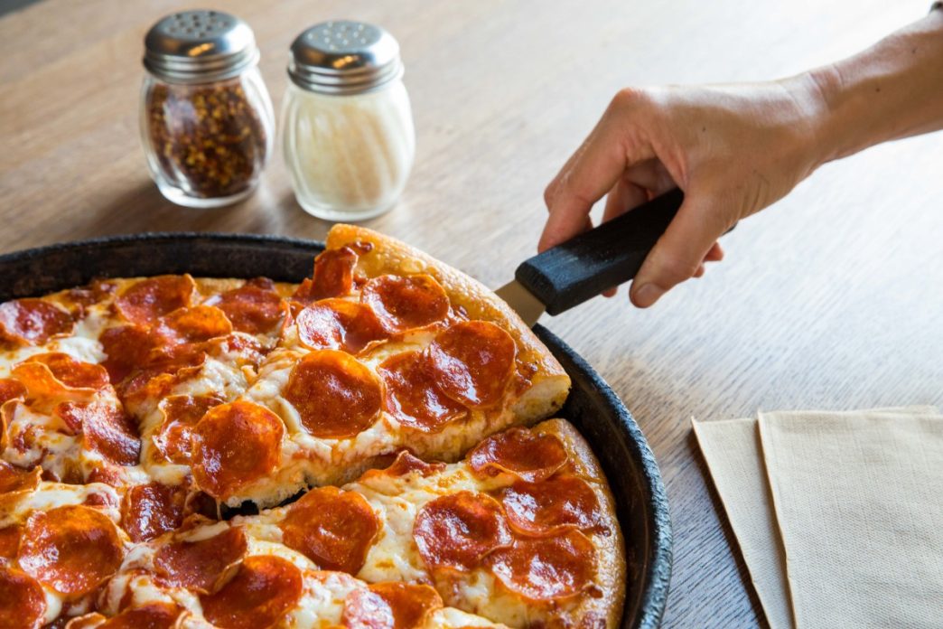 Bankrupt pizza chain operator sells dozens of