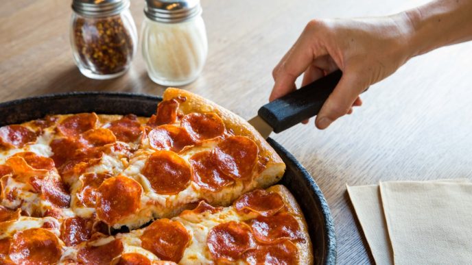 Bankrupt pizza chain operator sells dozens of