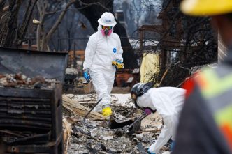 Environmental workers race to clear toxic debris