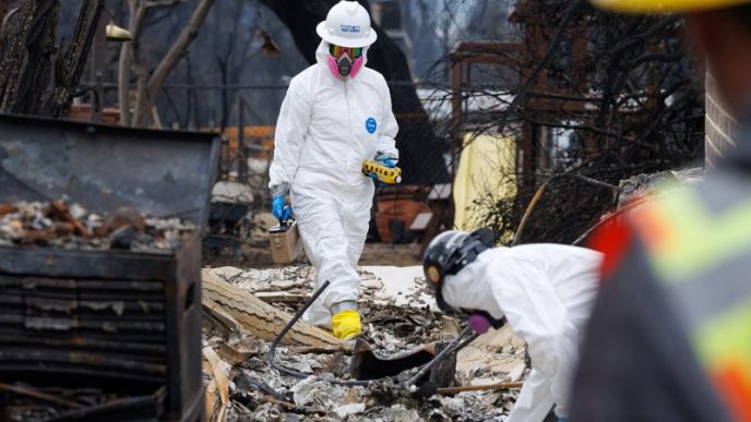 Environmental workers race to clear toxic debris