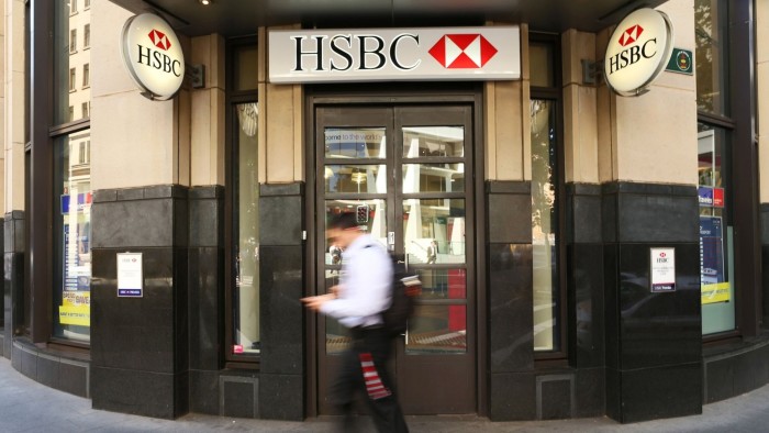 A pedestrian walks past an HSBC bank branch in Sydney