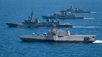 Australian naval vessels on exercise in 2024 in waters off the coast of The Philippines. In 2024, Australia announced defence spending would increase 6.3 per cent in the next fiscal year