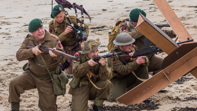 Soldiers with guns on beach