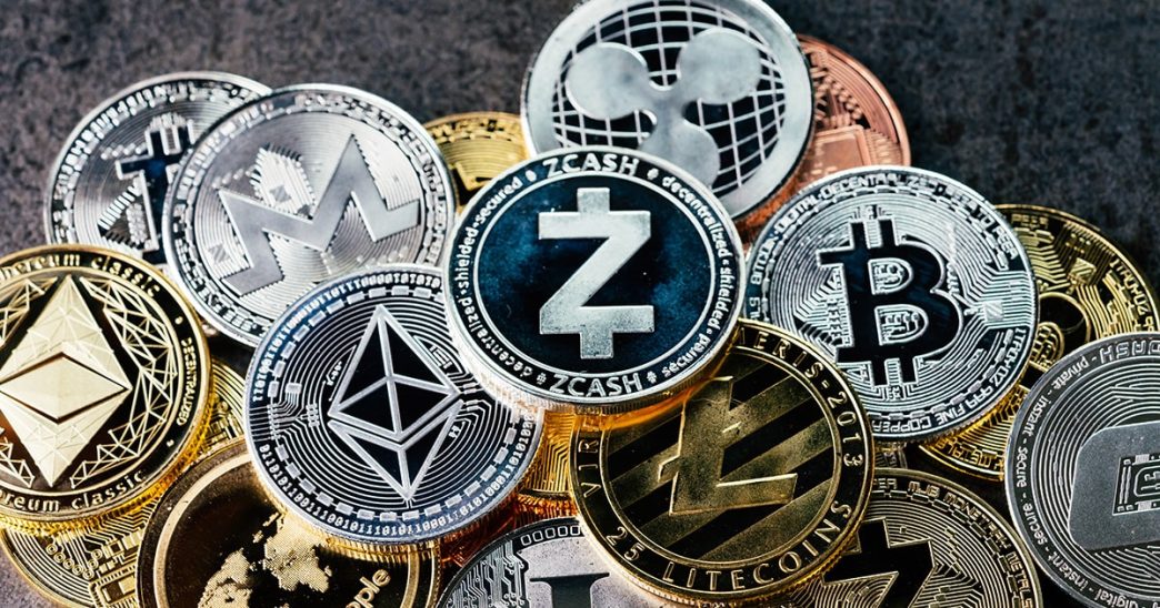 Ether, Bitcoin and other cryptocurrencies represented as actual coins